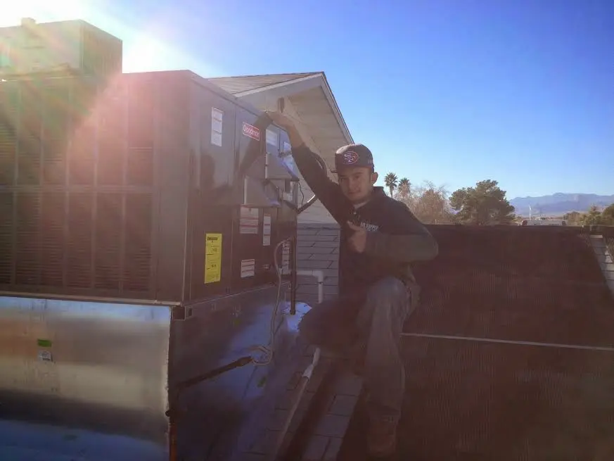 HVAC technician performing Heat Pump Repair on a rooftop unit in Agoura Hills